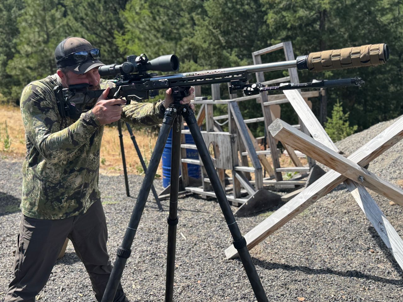 fundamentalsLevel1Image A man aims down the scope of a long-range rifle mounted on a tripod.